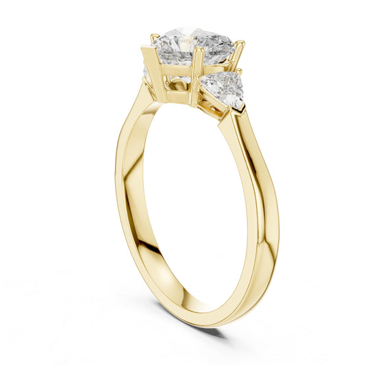 Side profile view highlighting a 2mm tapered shank with a low three stone basket setting holding a heart stone and trillion accents in 10k solid gold. An ideal anniversary gift and custom promise band. Tailored for you in personalized 10k/14k gold, 925 silver, platinum options with 1ct to 2ct center sizes in moissanite or lab grown diamond.