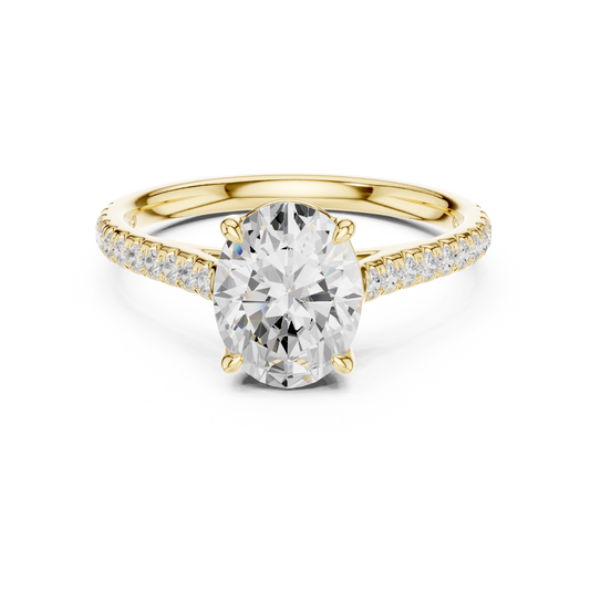 Front angle of an elongated oval cut main stone set in 14k gold with a micro pave band and claw prongs. Ideal as an engagement ring or anniversary gift, fully customizable in 10k/14k gold, 925 silver, or platinum with stone options from 1ct to 2ct in moissanite or lab grown diamond.