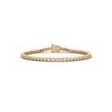 Round brilliant cut moissanite tennis bracelet set in 14k solid gold displaying 80 stones in smooth bezel cup mounts. Articulated link alignment delivers radiant bridal jewelry sparkle for an anniversary gift. Available custom in 10k/14k gold, 925 silver, platinum, stone sizes 1ct to 10ct tcw, and stone variation moissanite or lab grown diamond.