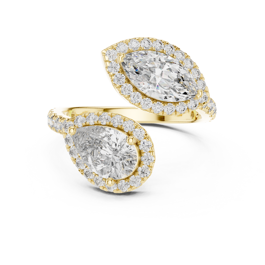 Top-down view of pear and marquise cut lab grown diamond bypass Toi et Moi ring featuring double halos and V-tip prongs on a 14k gold pave band. Ideal modern engagement ring and personalized gift. Made to order in 925 silver, 10k or 14k solid gold, platinum, with custom 1ct to 2ct tw lab diamond or moissanite stones.