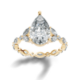 Front view of a brilliant pear cut Moissanite in 14k yellow gold 3-prong basket setting. Showcases top-tier colorlessness and symmetry on an accent band. Perfect choice for an engagement ring or anniversary gift. Custom options include 10k/14k gold, 925 silver, platinum with 1ct to 2ct moissanite or lab grown diamond centers.