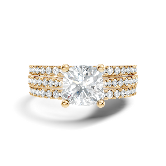Front angle of a cushion cut main stone set in 14k gold with a triple row pave band and four claw prongs. Ideal as an engagement ring or anniversary gift, fully customizable in 10k/14k gold, 925 silver, or platinum with stone options from 1ct to 2ct in moissanite or lab grown diamond.