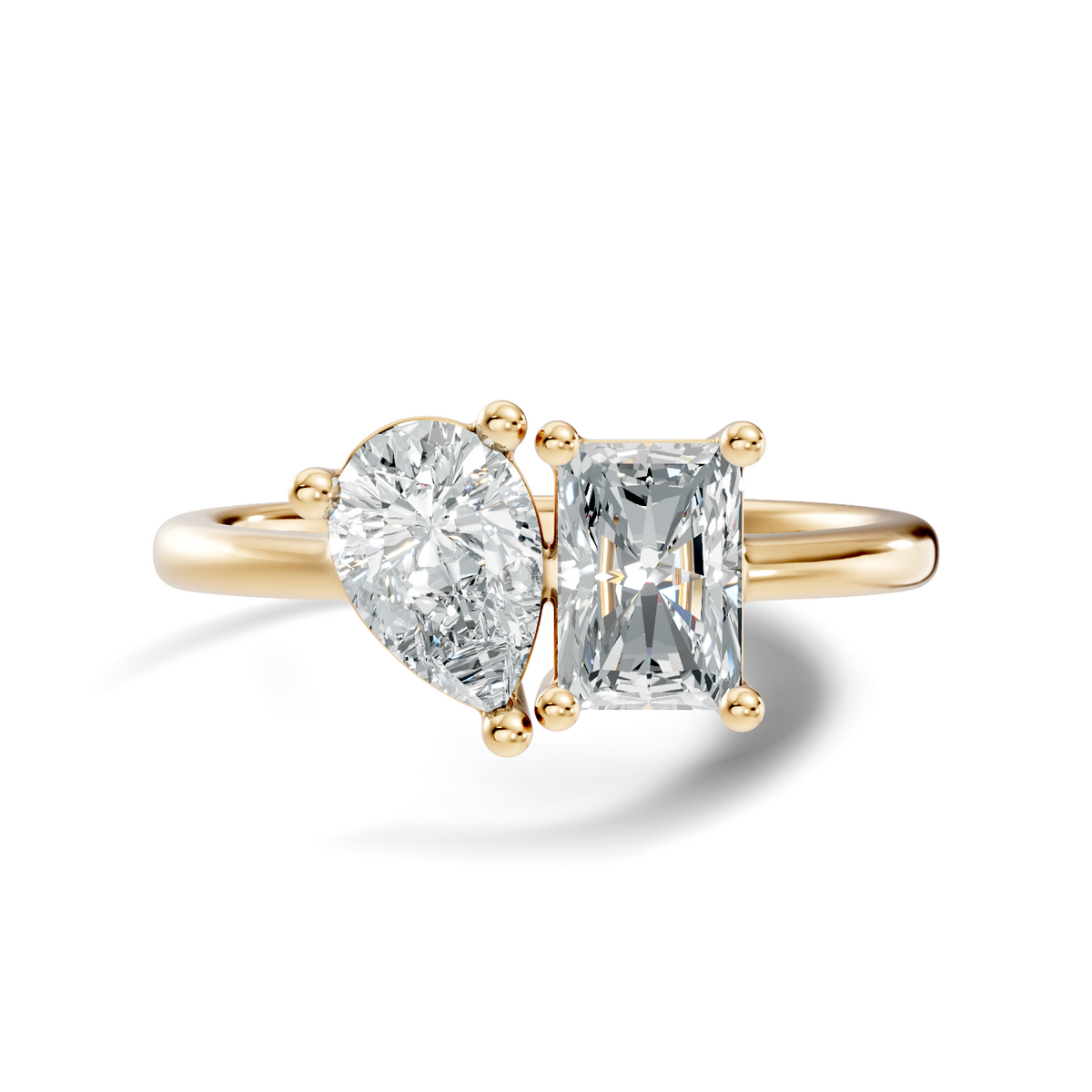 Front view showing a Toi et Moi two-stone setting with a pear cut and radiant cut stone held by secure basket prongs on a sleek rose gold band. Custom made in 925 silver, 10k or 14k gold, and platinum options. Perfect as an engagement ring or anniversary gift with customizable 1ct to 2ct moissanite or lab grown diamond.