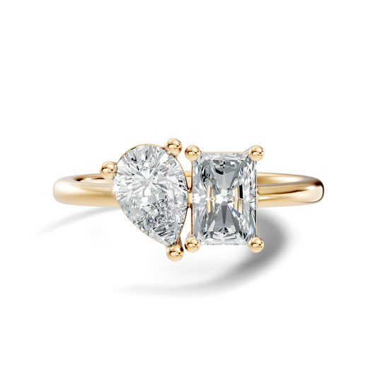 Front view showing a Toi et Moi two-stone setting with a pear cut and radiant cut stone held by secure basket prongs on a sleek rose gold band. Custom made in 925 silver, 10k or 14k gold, and platinum options. Perfect as an engagement ring or anniversary gift with customizable 1ct to 2ct moissanite or lab grown diamond.