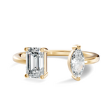 Top-down view of open bypass ring showcasing emerald cut stone facing marquise cut stone on slim band. High-volume engagement ring, anniversary gift, wedding band. Custom options in 10k/14k gold, 925 silver, platinum with 1ct to 2ct moissanite or lab grown diamond.