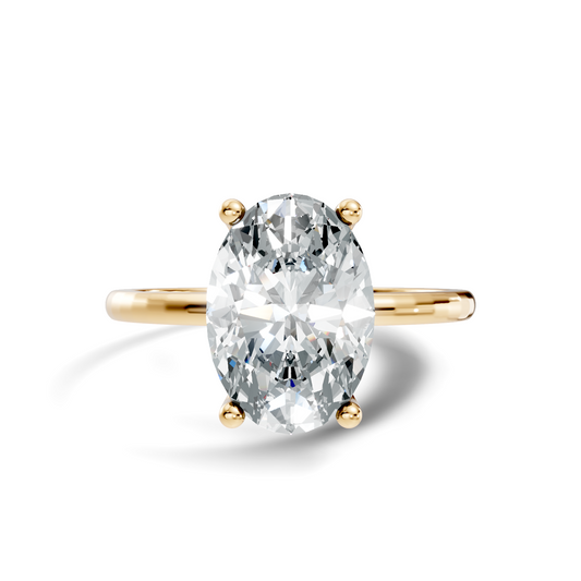 Front view showcasing an elongated oval cut center stone set on a delicate polished 14k gold band. Custom made in 925 silver, 10k gold, or platinum options. Classic engagement ring or anniversary gift featuring customizable 1ct to 2ct moissanite or lab grown diamond centers.