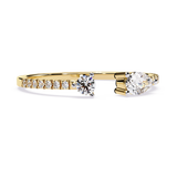 Front angle view of an open bypass toi et moi ring featuring pear and round lab grown diamonds in 14k white gold. This customizable engagement ring and anniversary gift option is available in 10k/14k gold, 925 silver, or platinum with lab grown diamond or moissanite stones from 1ct to 2ct.