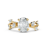 Front view of an elongated oval lab grown diamond set in 14k solid gold 4-claw prongs with leaf and vine side accents. High-volume engagement ring, anniversary gift, wedding band. Custom choices in 10k/14k gold, 925 silver, platinum with 1ct to 2ct moissanite or lab grown diamond.