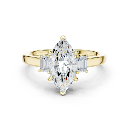 Front angle of a marquise cut main stone set in 14k gold with V-prongs and emerald side stones in a three-stone setting. Ideal as an engagement ring or anniversary gift, fully customizable in 10k/14k gold, 925 silver, or platinum with stone options from 1ct to 2ct in moissanite or lab grown diamond.